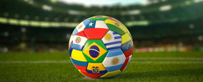 soccer ball with South American flags on it in a stadium