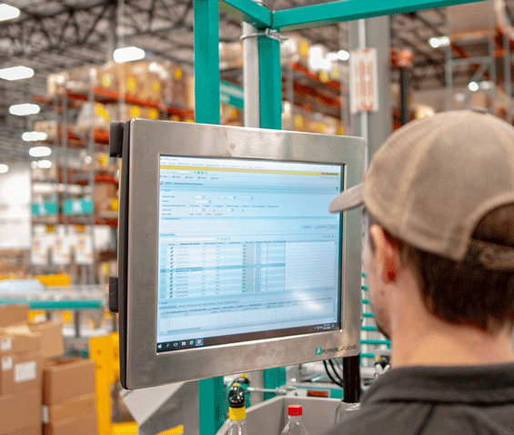 employee looking at the warehouse management software (WMS) system