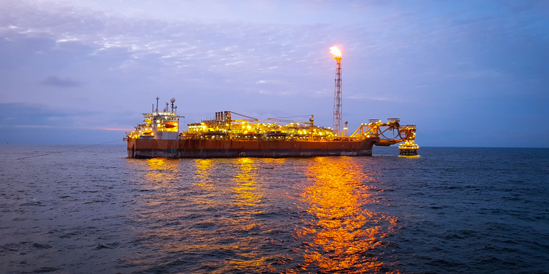 an FPSO vessel at high sea after sunset